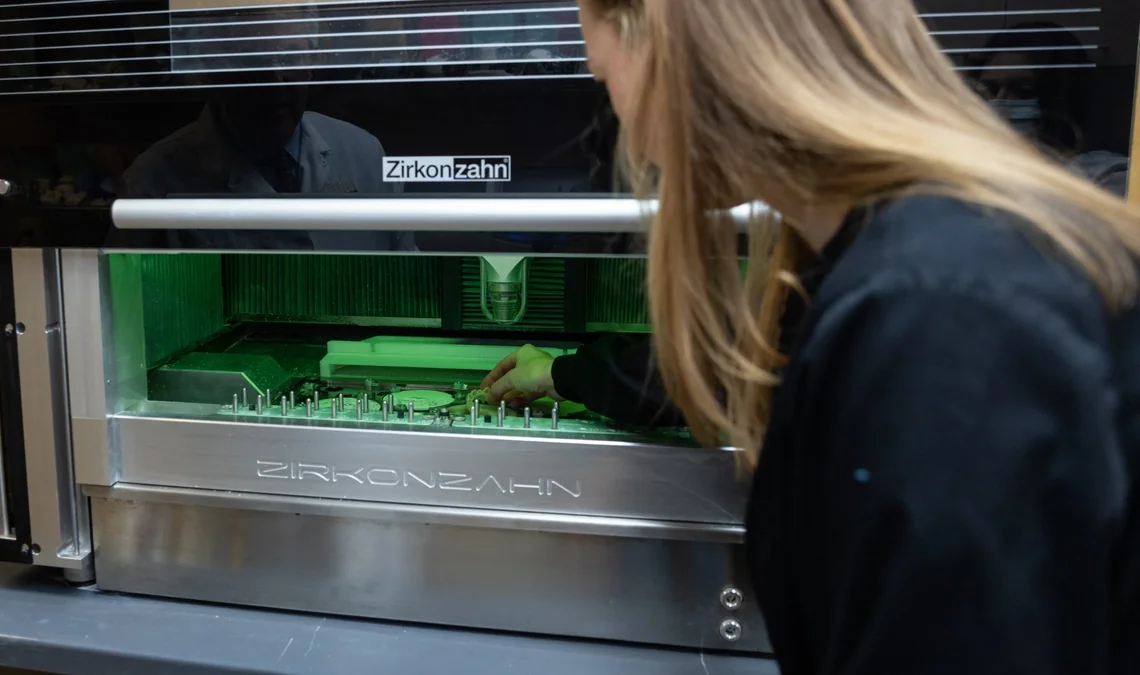 A technician loading a Zirkonzahn milling unit